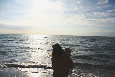 Rear view of man standing on beach