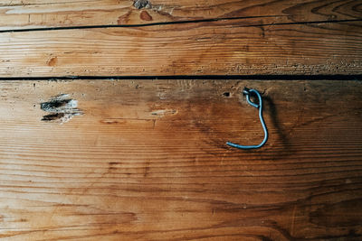 Metal hook on wooden wall