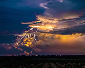 Lightning in cloudy sky during sunset