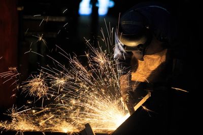 Worker welding indoors