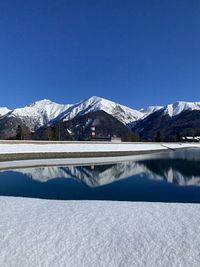 Scenic view of snowcapped mountains against clear blue sky