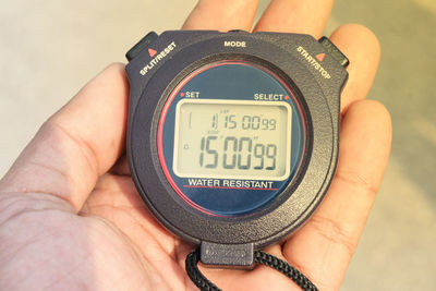 Close-up of hand holding stopwatch