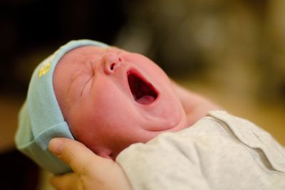 Close-up of baby boy yawning
