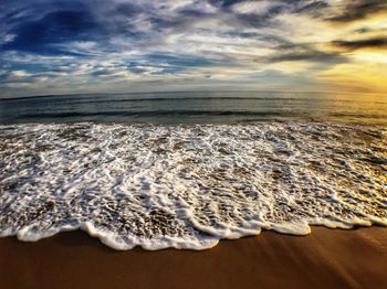 Scenic view of sea against cloudy sky