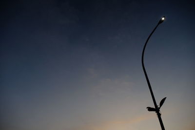 Low angle view of silhouette street light against sky