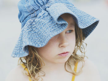 Close-up portrait of cute girl wearing hat