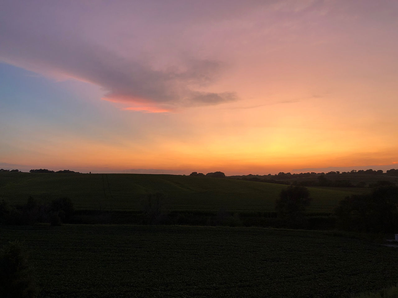 sky, landscape, sunset, environment, scenics - nature, beauty in nature, field, land, cloud, nature, horizon, tranquility, dawn, tranquil scene, agriculture, plant, rural scene, no people, plain, evening, orange color, afterglow, sun, dramatic sky, tree, hill, outdoors, idyllic, silhouette, sunlight, farm, non-urban scene, red sky at morning, grass, architecture