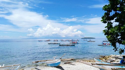 Boats moored on sea against sky