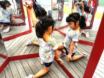 High angle view of cute girl reflecting on mirror