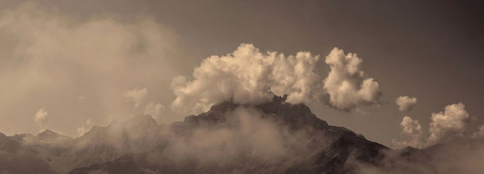 Low angle view of volcanic mountain against sky