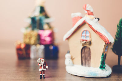 Santa clause figurine with decorations and christmas presents on table