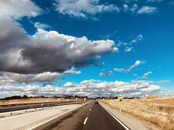 Road passing through landscape against sky