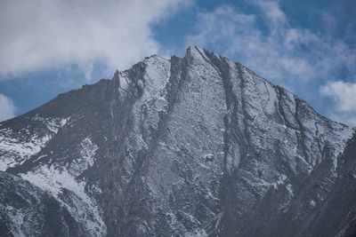 Low angle view of snowcapped mountain against sky