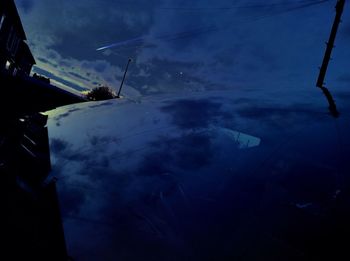 Boat in sea against cloudy sky