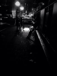 People walking in city at night