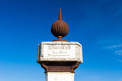 Low angle view of clock tower against blue sky