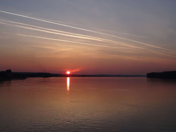 Scenic view of sea against romantic sky at sunset