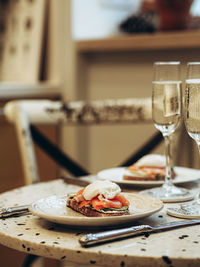 Sunday brunch with prosecco and eggs and salmon bruschetta on marble table at home on kitchen