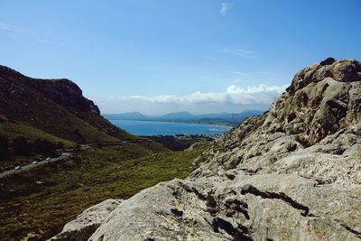 Scenic view of mountains against blue sky
