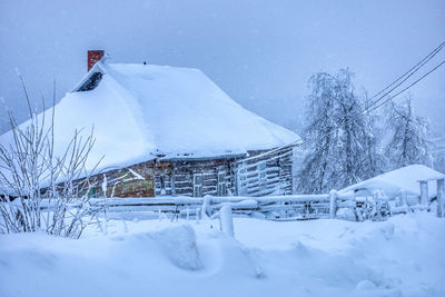 Snow covered field against sky