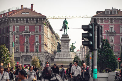 Group of people in front of buildings in city