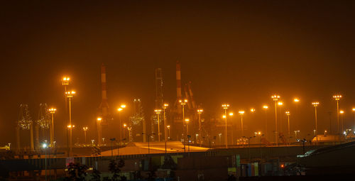 Illuminated buildings in  city port at night