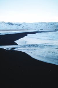 Scenic view of sea against sky during winter