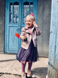 Portrait of smiling girl standing outdoors