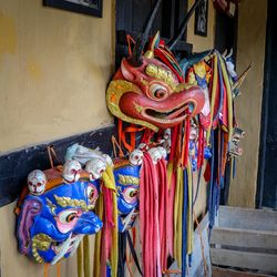 Multi colored masks hanging on wall