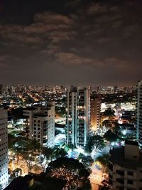 High angle view of illuminated buildings against sky at night