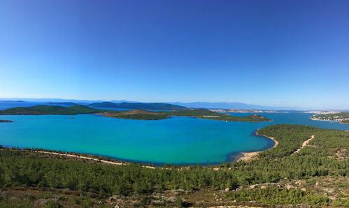 Scenic view of bay against clear blue sky