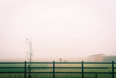 Fence on field against sky