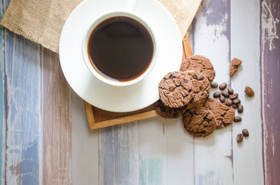 High angle view of coffee and cookies on table