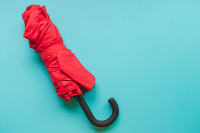 High angle view of red umbrella against blue background