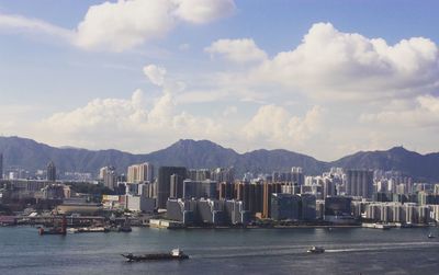 Scenic view of sea by city against sky