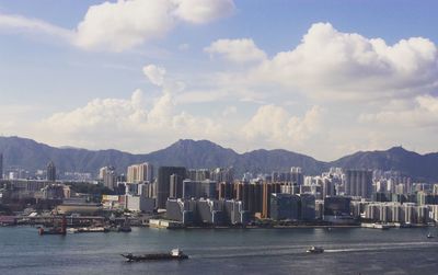 Scenic view of sea by city against sky