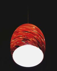 Low angle view of illuminated light bulb against black background