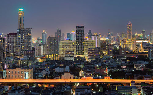 View of skyscrapers lit up at night