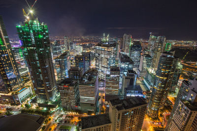 High angle view of illuminated buildings in city at night