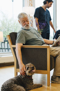 Man and dog sitting at home