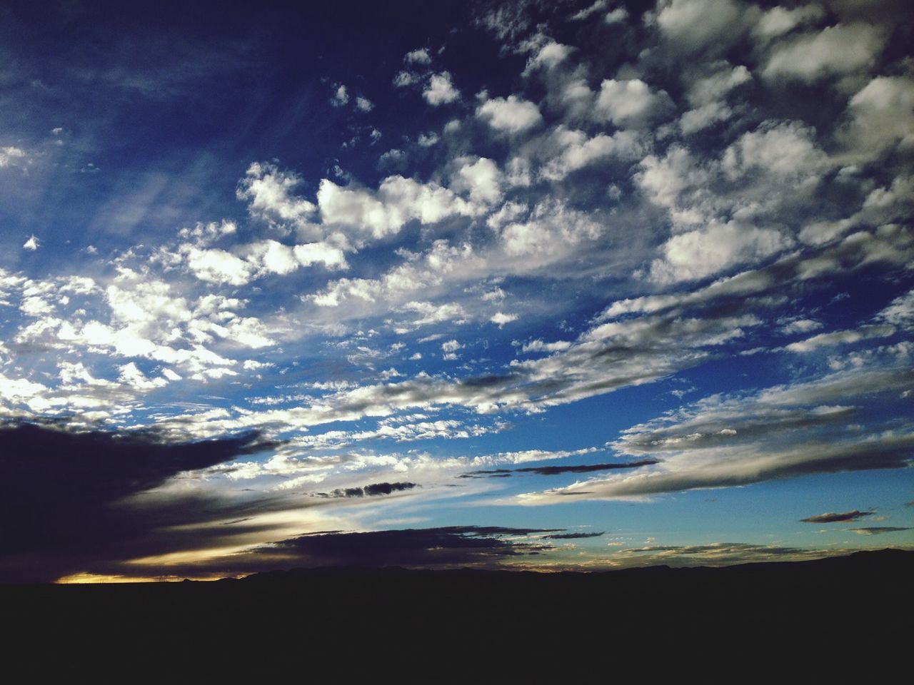 sky, tranquil scene, scenics, tranquility, beauty in nature, cloud - sky, silhouette, nature, landscape, cloud, idyllic, cloudy, sunset, dusk, outdoors, dark, majestic, cloudscape, no people, non-urban scene