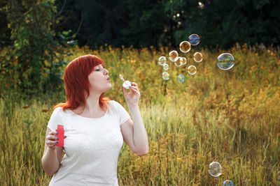 Young woman blowing bubbles