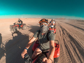 People riding motorcycle on desert