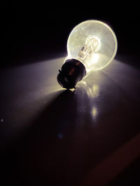 Close-up of light bulb on table