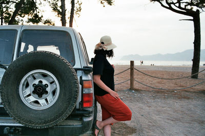 Woman standing near by suv