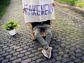 Low section of woman walking on footpath