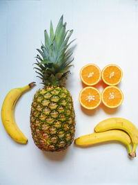 Various fruits on table against white background