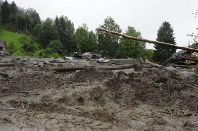 Abandoned machinery on field against sky