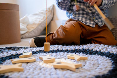 Low section of woman lying on bed at home