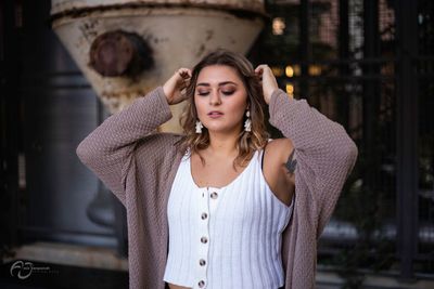 Portrait of beautiful young woman standing outdoors